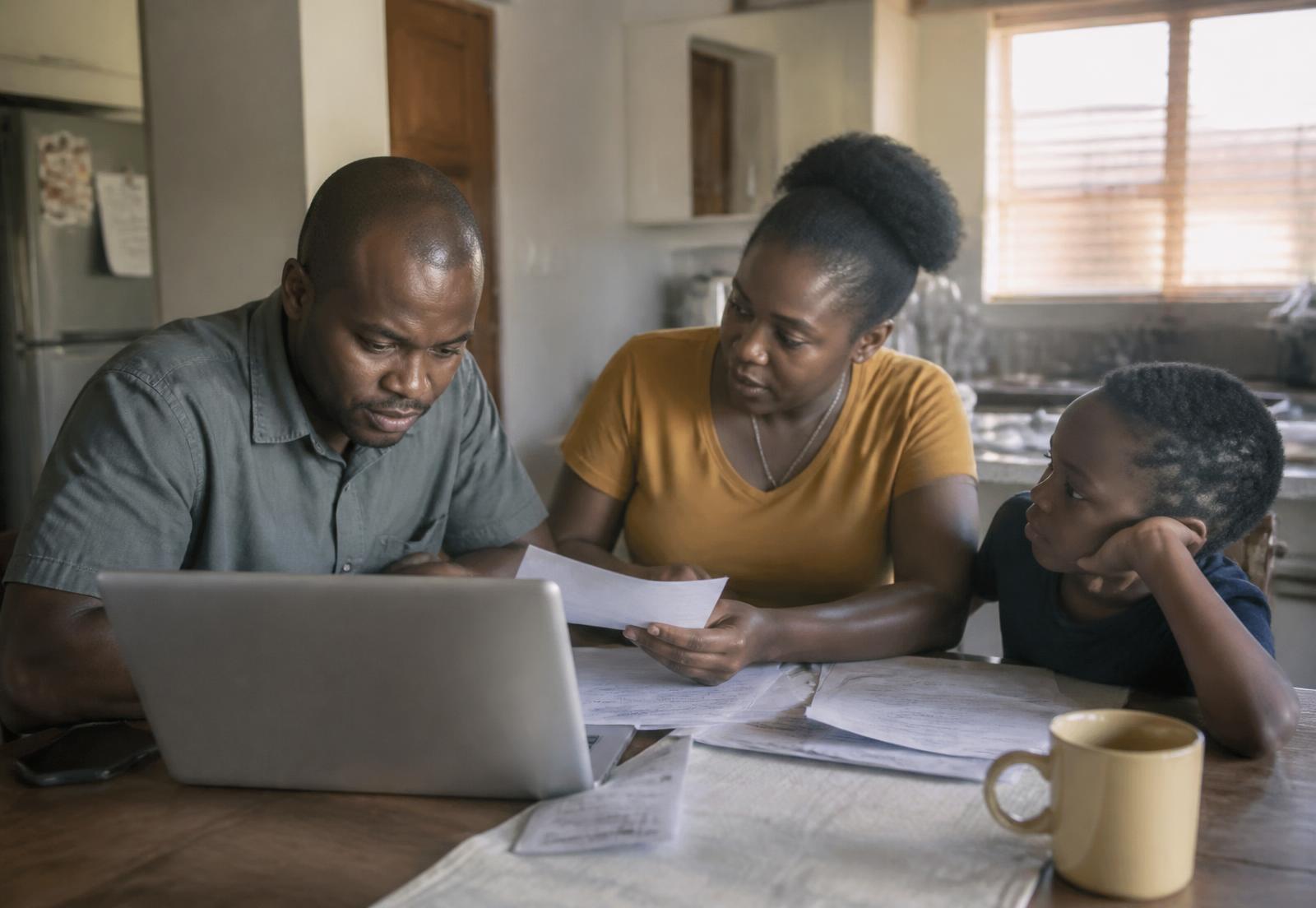 A South African family reviewing their finances together at home